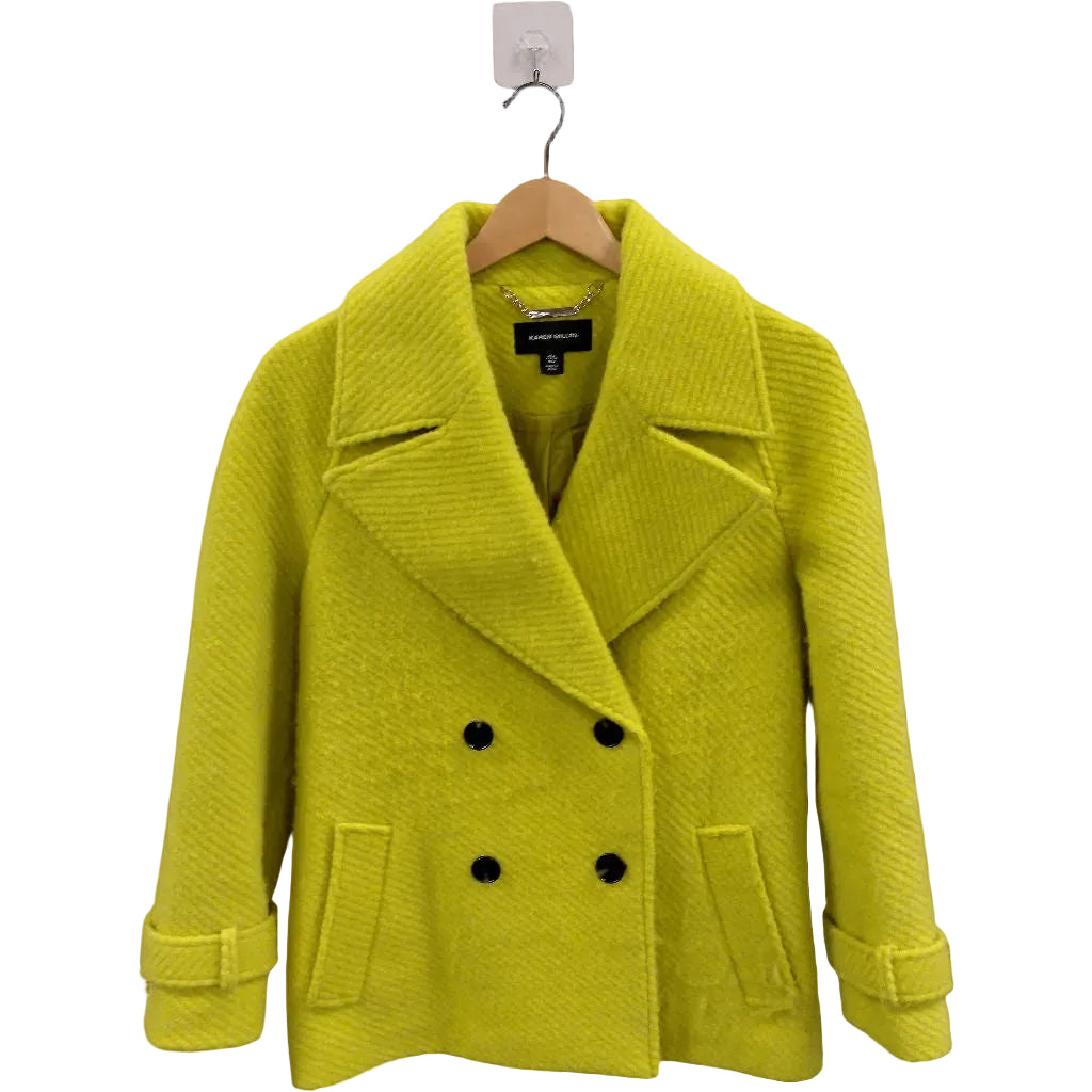Yellow coat on a hanger against a white background